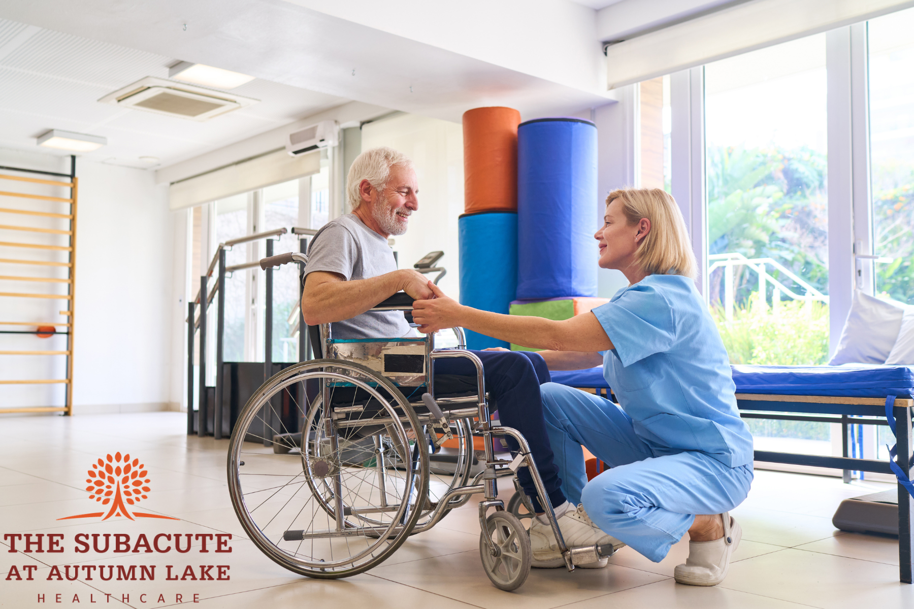 Nurse assisting a senior man in a wheelchair at an assisted living gym.